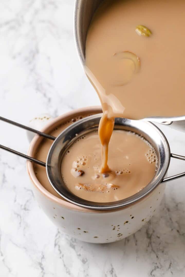 This cozy vegan spiced chai chai is creamy, warmly spiced, and easy to make at home with oat milk and whole spices. Straining spiced chai before serving.
