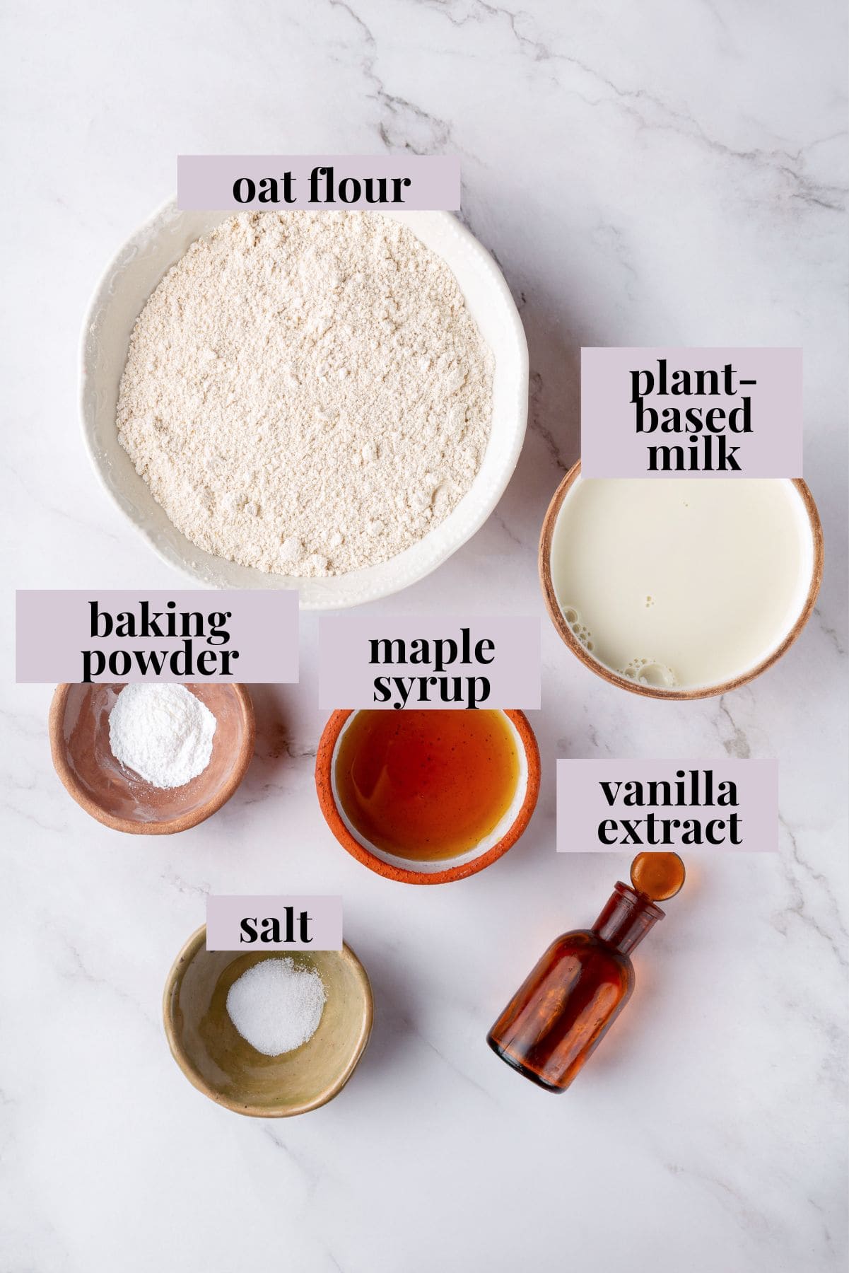 These oat flour pancakes are thick and fluffy, made with simple ingredients and they're naturally gluten-free and vegan. A game changer! Ingredients for oat flour pancakes with labels.