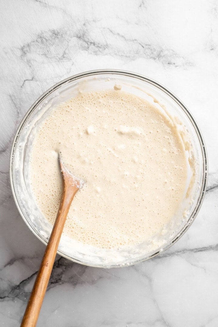 These fluffy sheet pan pancakes bake in one pan for an easy, no-flip breakfast that’s perfect for busy mornings or brunch. Stirring bowl of batter for sheet pan pancakes.