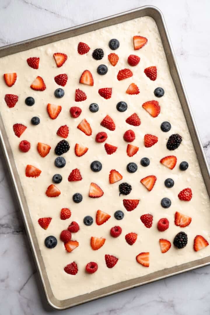 These fluffy sheet pan pancakes bake in one pan for an easy, no-flip breakfast that’s perfect for busy mornings or brunch. Berries added to batter for sheet pan pancakes.
