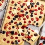 Pan of sliced sheet pan pancakes with berries.