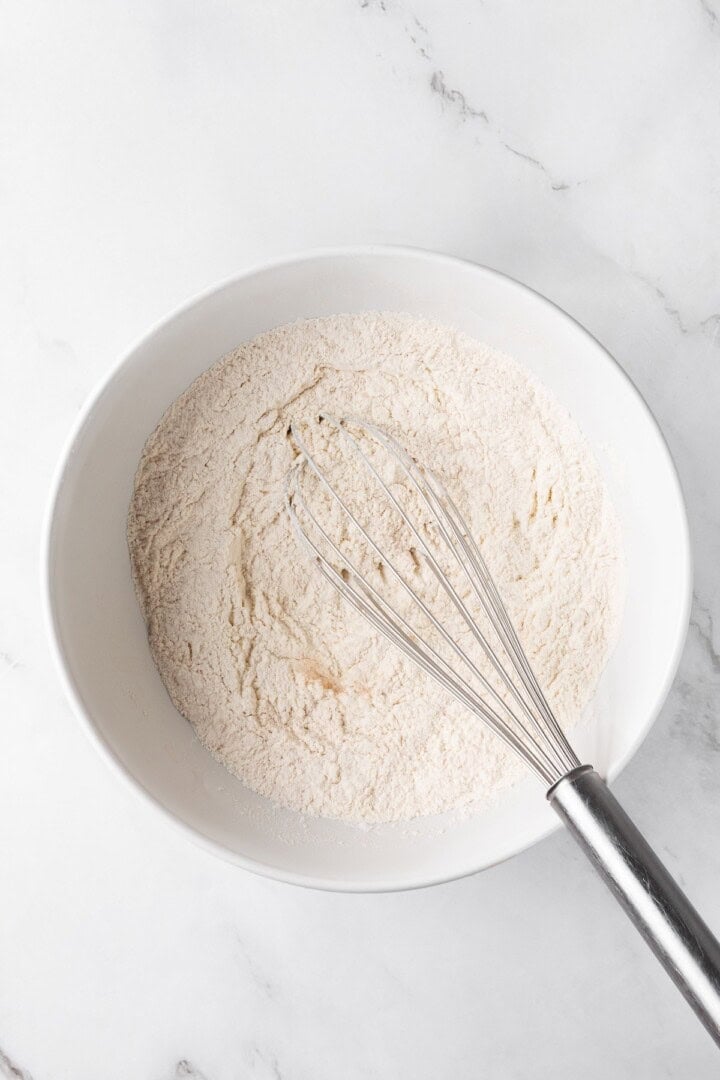 This easy upside down apple cake features tender, spiced cake topped with sticky caramel apples. It’s cozy, simple and perfect for fall! Whisk in bowl with dry ingredients for cake.