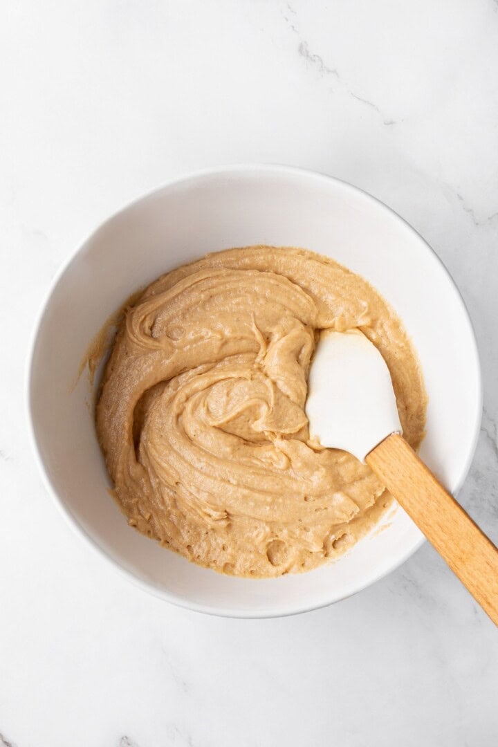 This easy upside down apple cake features tender, spiced cake topped with sticky caramel apples. It’s cozy, simple and perfect for fall! Batter for upside down apple cake in mixing bowl.