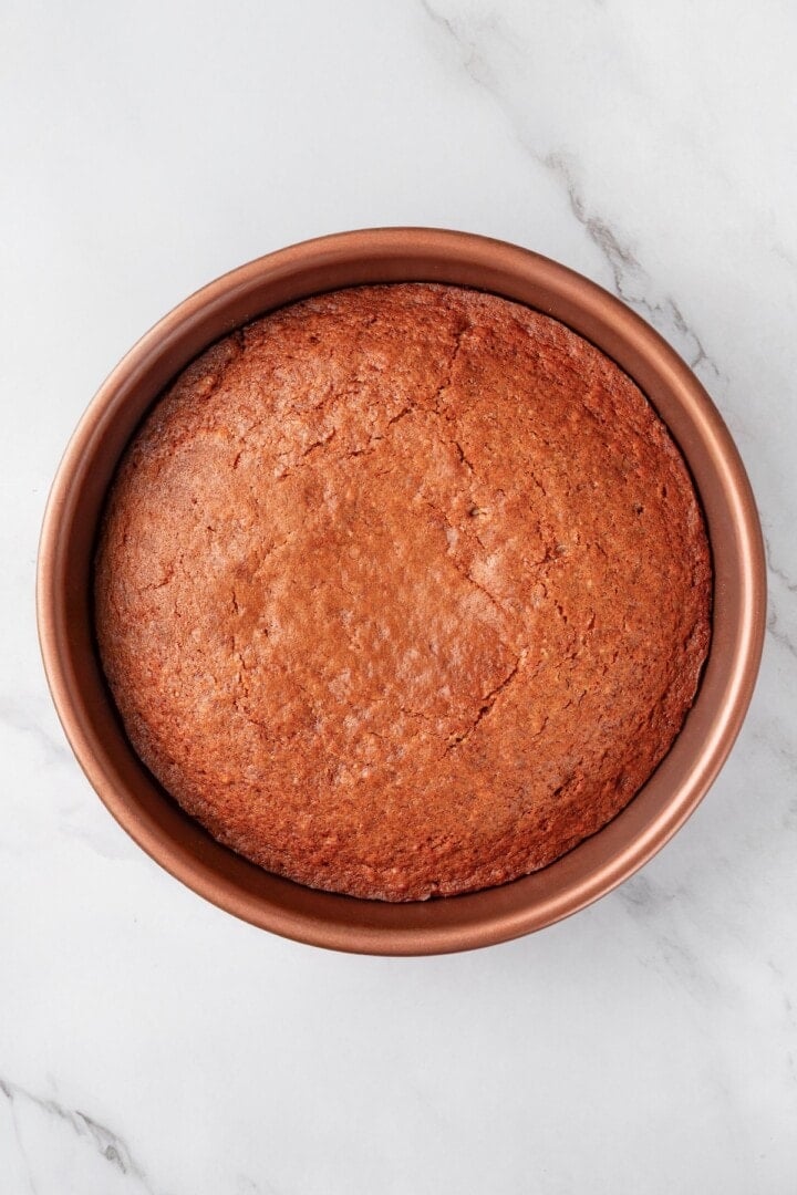 This easy upside down apple cake features tender, spiced cake topped with sticky caramel apples. It’s cozy, simple and perfect for fall! Vegan upside down apple cake in pan.