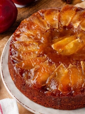 Vegan upside down apple cake on serving plate.
