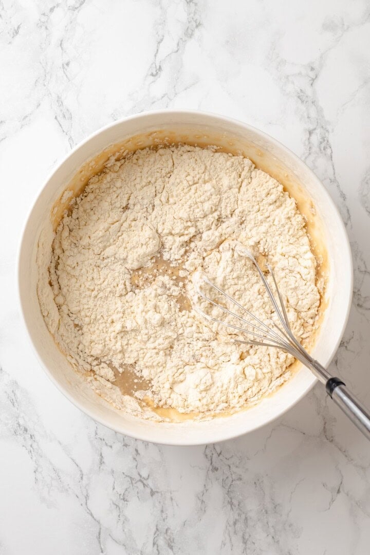 German pancakes bake up puffy and golden with crisp edges and a tender middle. Aquafaba stands in for the eggs in this easy vegan recipe! Whisk mixing batter for German pancakes.