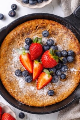 German pancake topped with blueberries and strawberries.