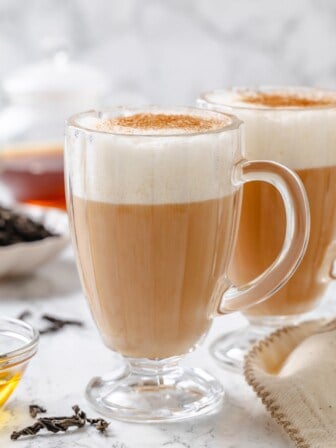 Two glass mugs filled with frothy London fog latte.