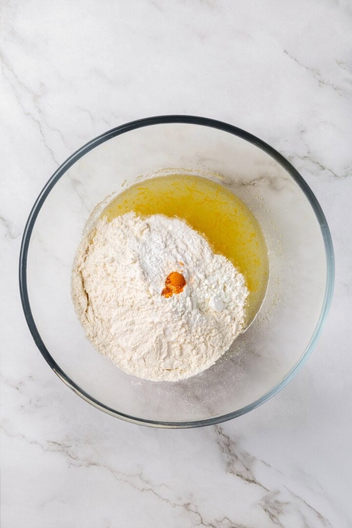 These vegan lemon crinkle cookies bake up soft and chewy, with a sunny citrus flavour and a classic powdered sugar crackle on top. Lovely! Dry ingredients added to bowl of wet ingredients for lemon crinkle cookie dough.