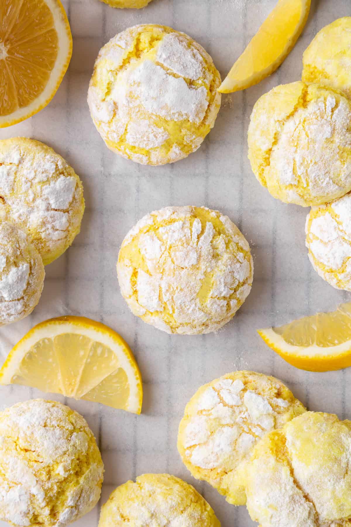 These vegan lemon crinkle cookies bake up soft and chewy, with a sunny citrus flavour and a classic powdered sugar crackle on top. Lovely! Lemon crinkle cookies on parchment paper lined wire rack.