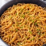 Pan of garlic noodles with green onions.