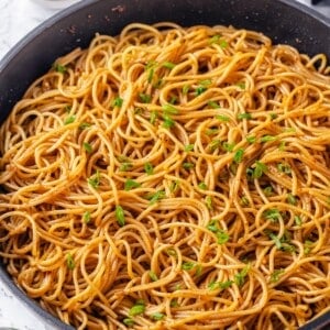 Pan of garlic noodles with green onions.