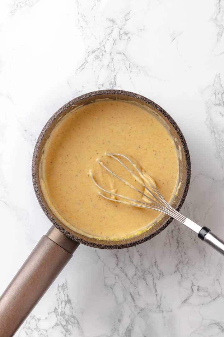 Whisking cream sauce for hashbrown casserole.