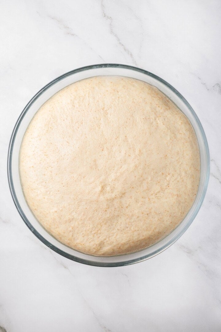 Tender and warm, with a perfect pocket in the middle, this easy homemade pita bread recipe gives your wraps, dips and sandwiches an upgrade! Pita bread dough in bowl after rising.