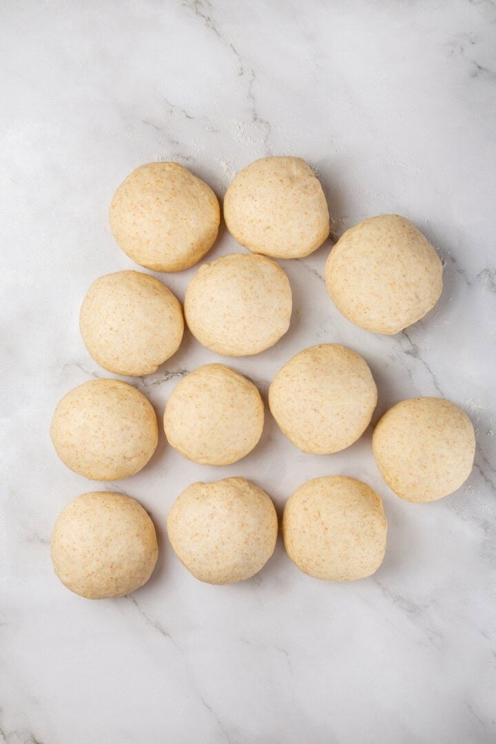 Tender and warm, with a perfect pocket in the middle, this easy homemade pita bread recipe gives your wraps, dips and sandwiches an upgrade! Dough portioned into rounds.