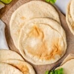 Pita bread on countertop and parchment paper.