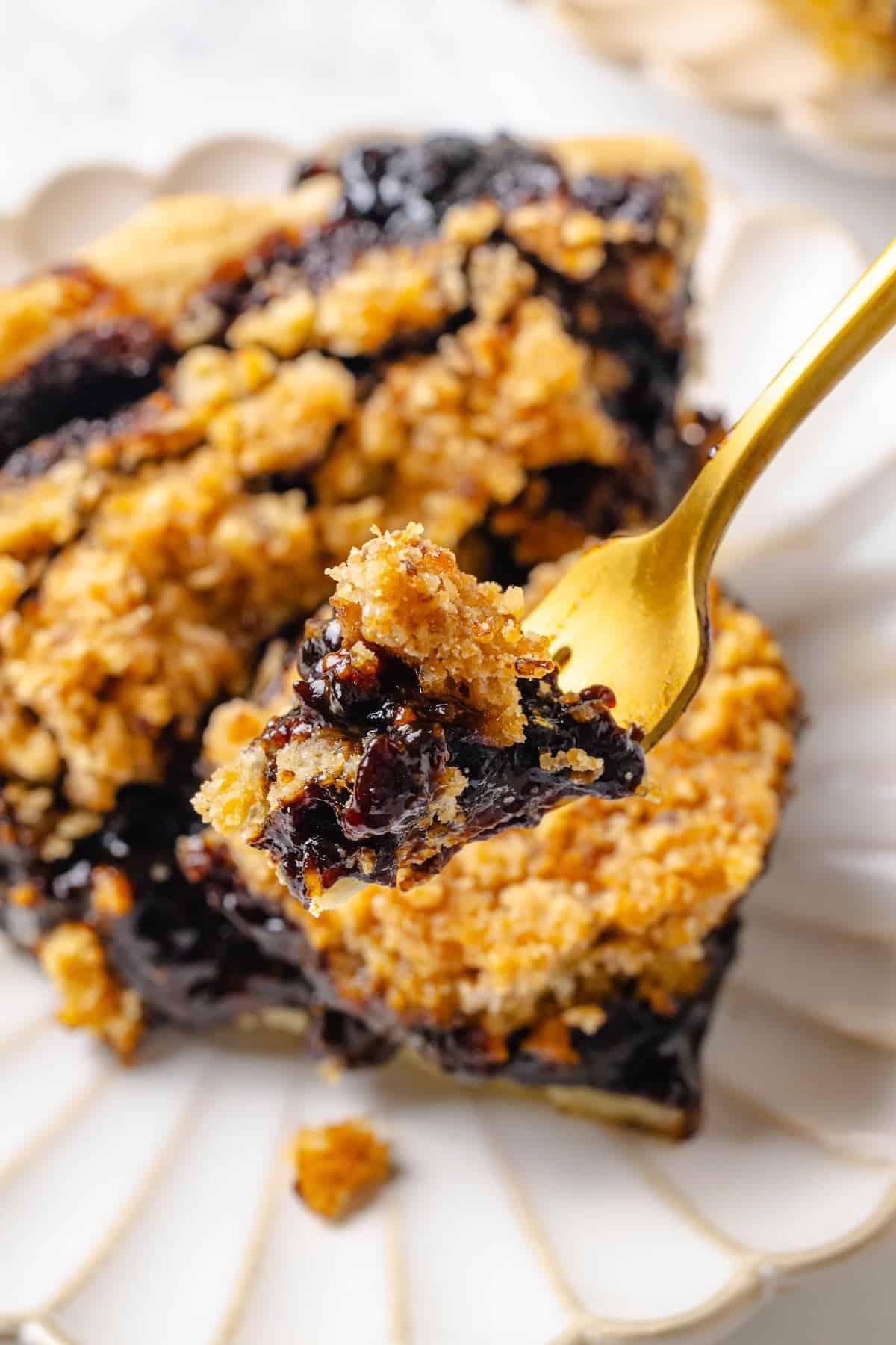 Forkful of vegan shoofly pie held over plate.