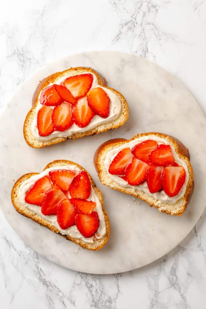 Golden, custardy, and filled with jammy berries and vanilla cream cheese, this vegan stuffed French toast turns brunch into something special! Cream cheese and strawberries added to slices of bread.