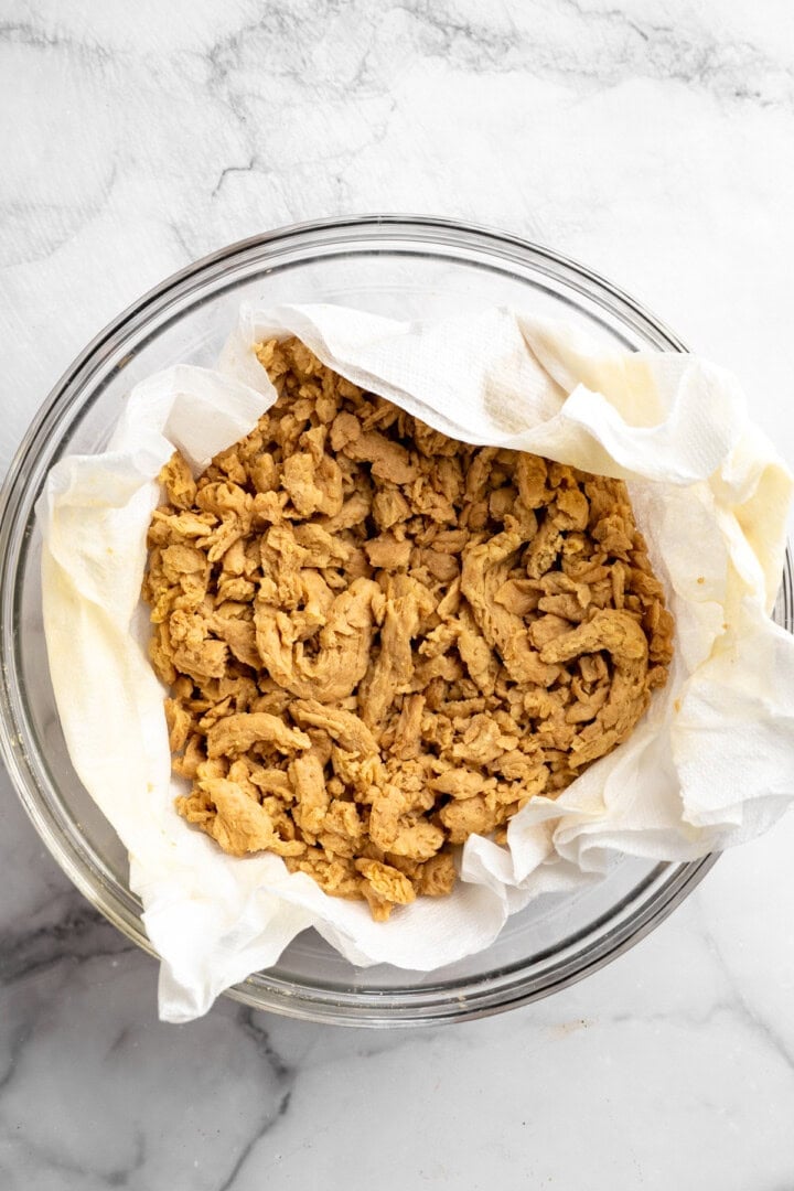 A little bit crispy, budget-friendly and packed with bold flavour, these BBQ soy curls are an easy vegan staple you’ll make again and again! Soy curls in paper towel lined bowl.