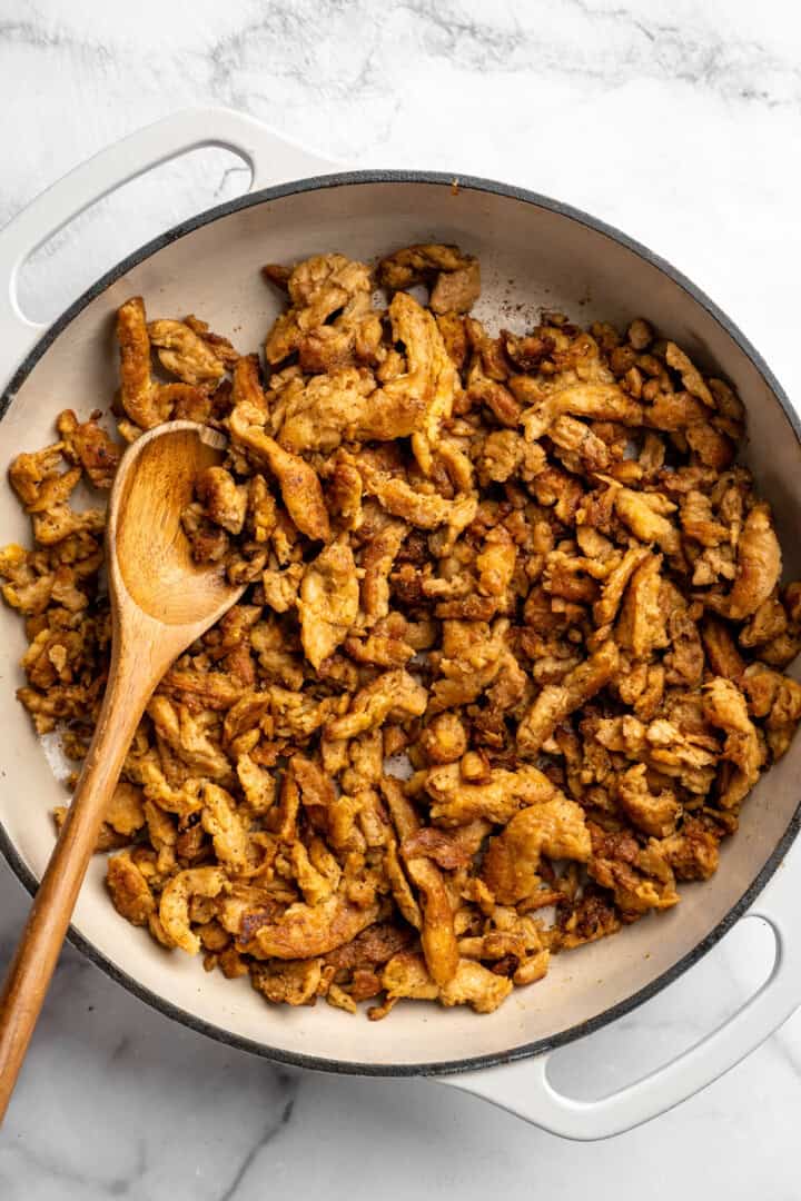 A little bit crispy, budget-friendly and packed with bold flavour, these BBQ soy curls are an easy vegan staple you’ll make again and again! Soy curls browning in pan.