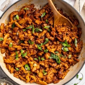Skillet of BBQ soy curls with green onions.