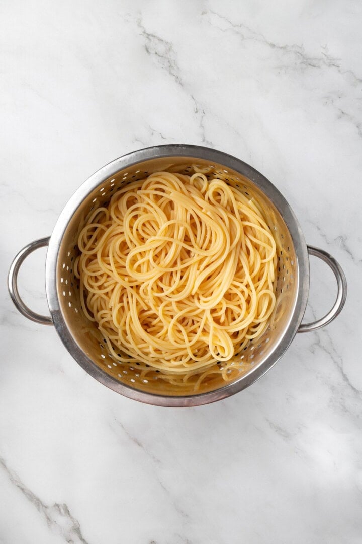 Cooked pasta in colander.