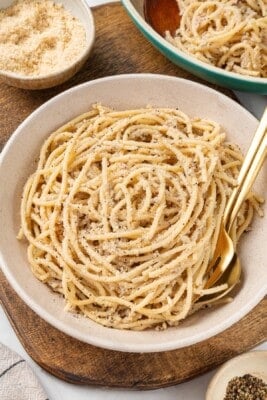 Bowl of cacio e pepe with fork and spoon.