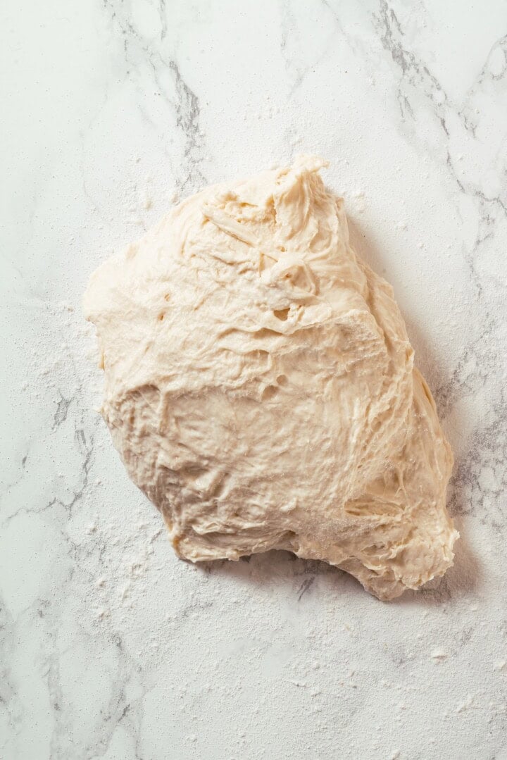 This Dutch oven sourdough bread gives you a bakery-style loaf with a crisp, golden crust and chewy interior. It's easier than you think! Sourdough bread dough on floured surface.
