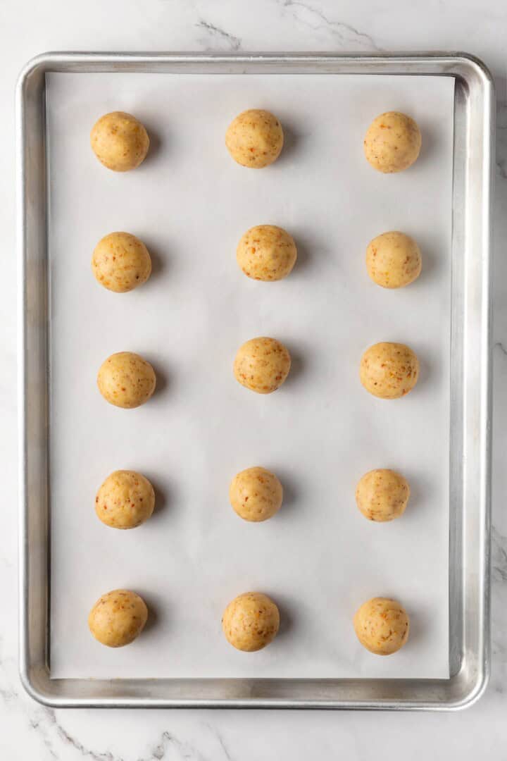 Buttery, melt-in-your-mouth and coated in powdered sugar, these vegan Mexican wedding cookies have everything you love about the original! Mexican wedding cookie dough on baking sheet.