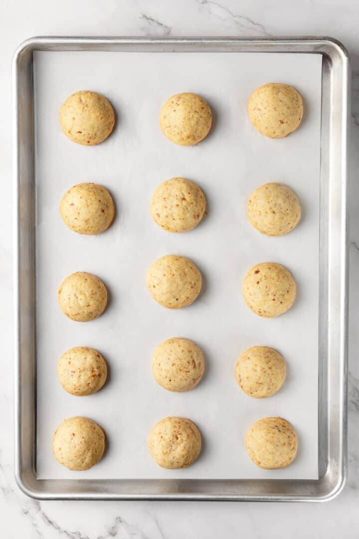 Buttery, melt-in-your-mouth and coated in powdered sugar, these vegan Mexican wedding cookies have everything you love about the original! Baked Mexican wedding cookies on pan before adding powdered sugar.