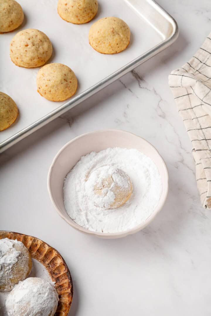 Buttery, melt-in-your-mouth and coated in powdered sugar, these vegan Mexican wedding cookies have everything you love about the original! Coating Mexican wedding cookie in sugar.