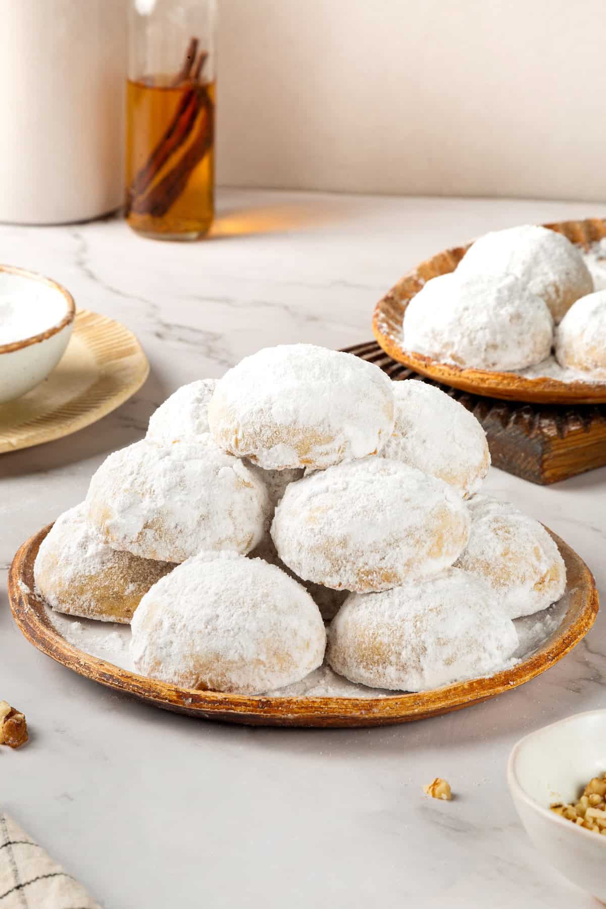 Buttery, melt-in-your-mouth and coated in powdered sugar, these vegan Mexican wedding cookies have everything you love about the original! Two plates of Mexican wedding cookies.