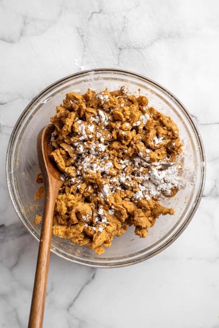 Soy curl "chicken" is a budget-friendly vegan swap for chicken that's crispy on the outside, full of savoury flavour, and super versatile! Stirring soy curls with cornstarch.