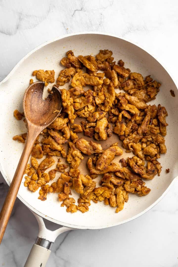 Soy curl "chicken" is a budget-friendly vegan swap for chicken that's crispy on the outside, full of savoury flavour, and super versatile! Skillet of soy curl chicken.