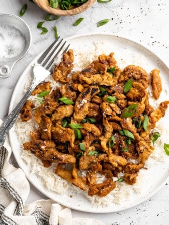 Soy curl chicken served on plate of rice.
