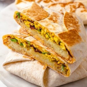 Vegan breakfast crunchwrap cut in half to show fillings.