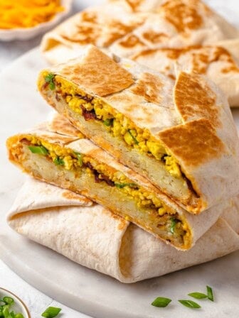 Vegan breakfast crunchwrap cut in half to show fillings.