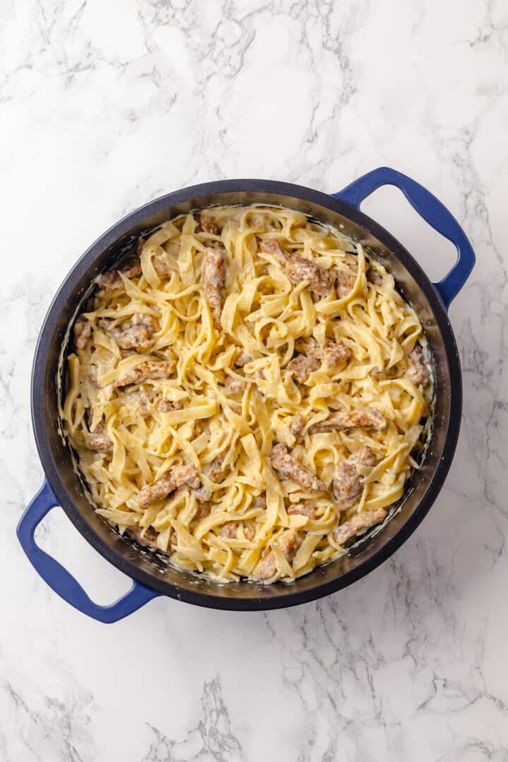 This vegan “chicken” Alfredo recipe is made with budget-friendly soy curls to replace the meat. It’s rich, garlicky and creamy. So good! Creamy soy curl chicken alfredo in pan.