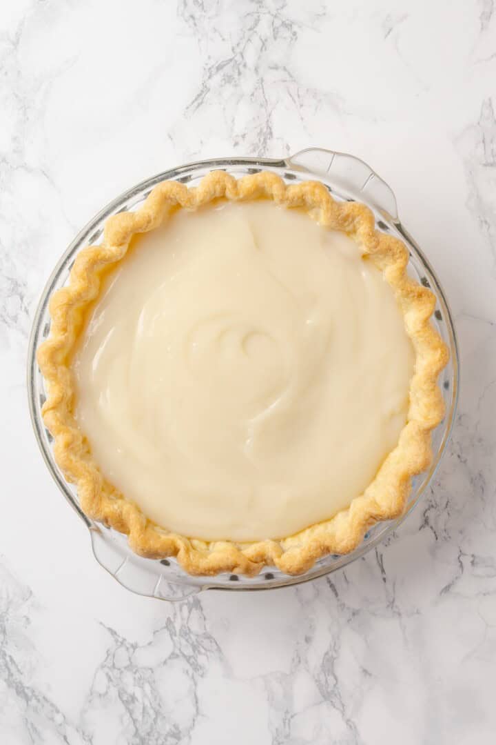 Custard filling added to pie crust.