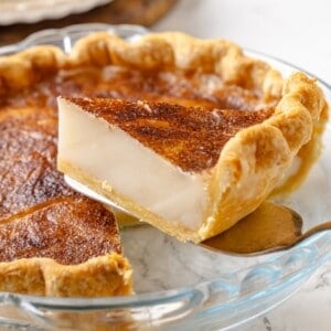 Lifting sugar cream pie slice from pan.