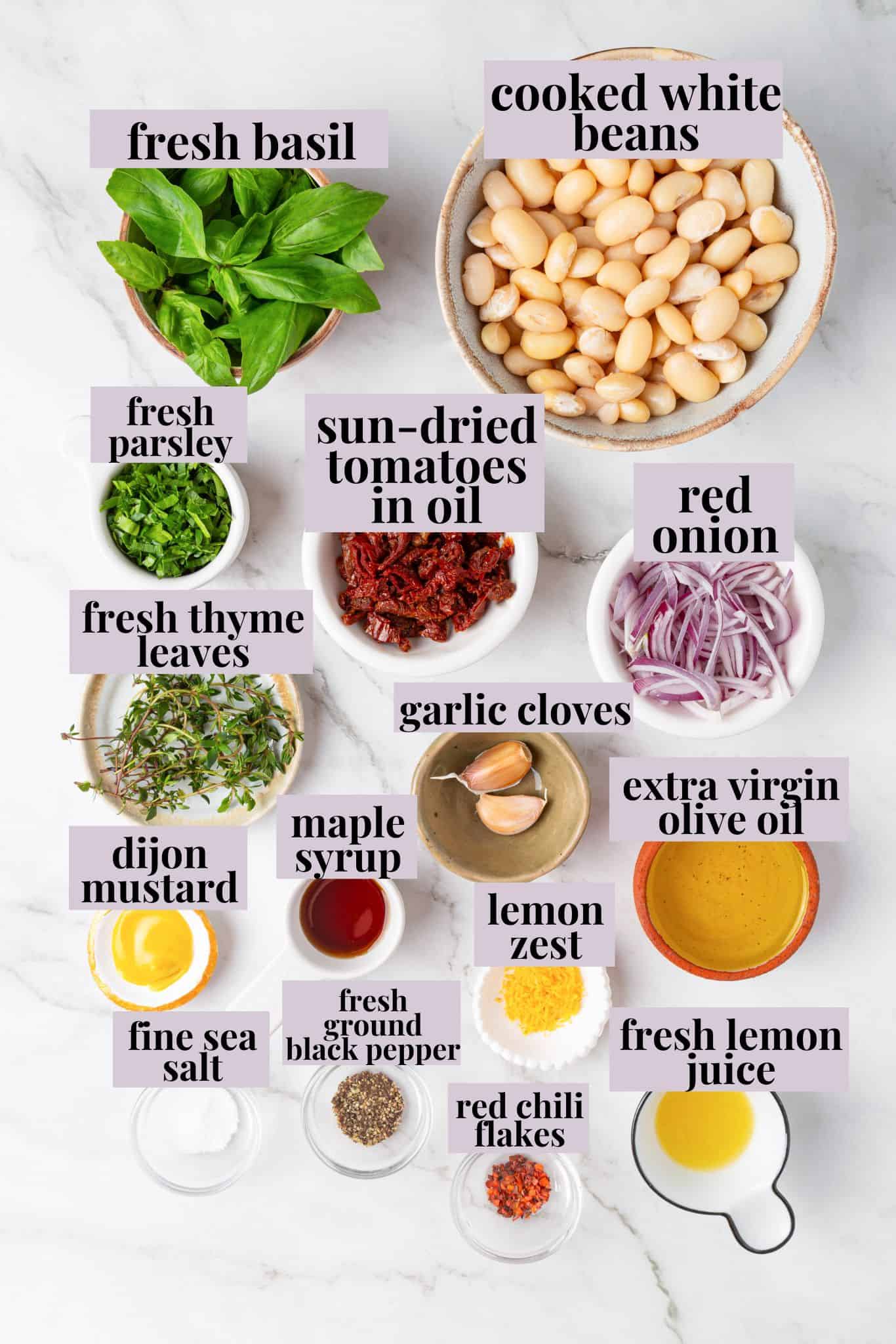 These easy marinated beans are soaked in a bright lemon-Dijon marinade with fresh herbs and aromatics. The perfect summer side. Labeled ingredients for marinated white beans.