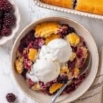 Overhead image of blackberry cobbler in a bowl.