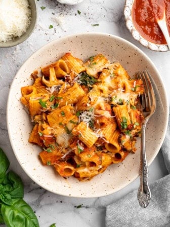 A serving of vegan pasta bake in a plate bowl.