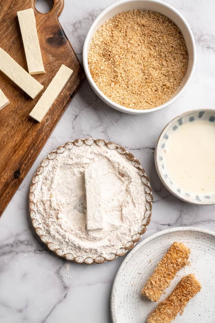 This tofu salad, topped with Cajun fried tofu and creamy, tangy-sweet dressing, is just as good as TGI Friday's version. And it's vegan! Dredging tofu strips in flour.