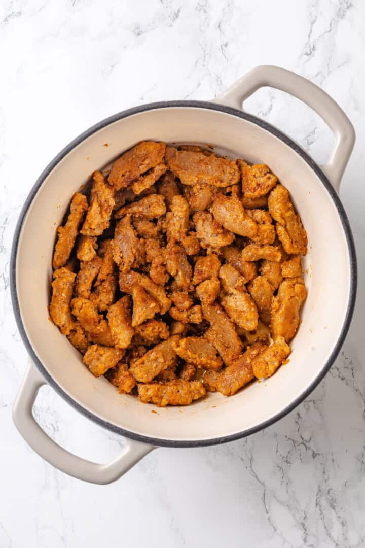 This vegan "chicken" and rice delivers all the cozy, savoury goodness of the meat-eater's version, no chicken required. Searing seasoned soy curls in a Dutch oven.