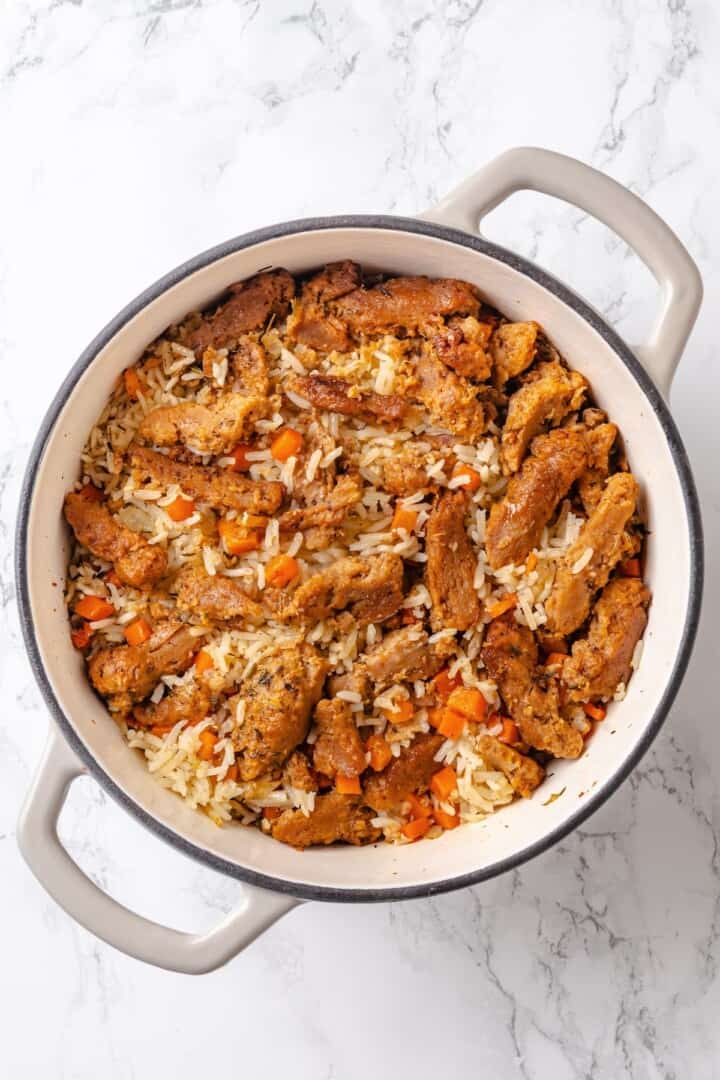 This vegan "chicken" and rice delivers all the cozy, savoury goodness of the meat-eater's version, no chicken required. Rehydrated, seasoned, and seared soy curls pressed lightly into a Dutch oven full of rice and aromatics.