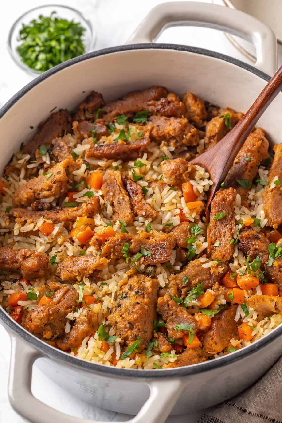 This vegan "chicken" and rice delivers all the cozy, savoury goodness of the meat-eater's version, no chicken required. A Dutch oven full of vegan chicken and rice.