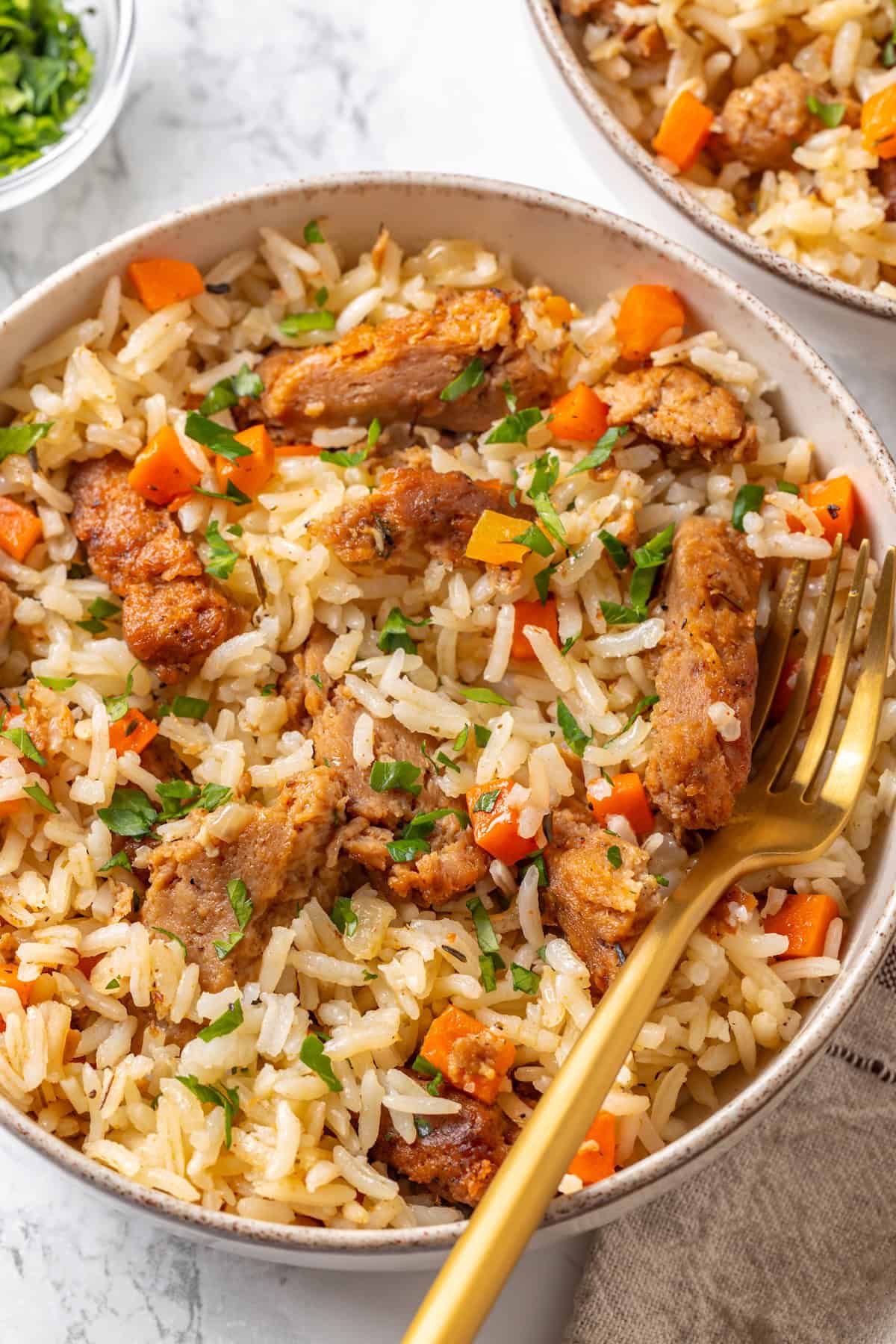 This vegan "chicken" and rice delivers all the cozy, savoury goodness of the meat-eater's version, no chicken required. Overhead image of a bowl of vegan chicken and rice made with soy curls.