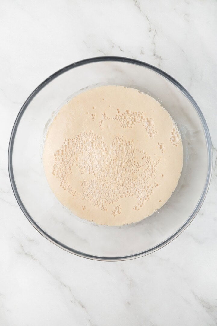This easy vegan Sandwich Bread Recipe is a home baker's dream. Soft and pillowy with a subtle richness, it's a major upgrade to any sandwich. Foaming warm water, yeast, and sugar in a bowl.