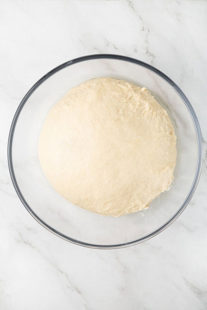 This easy vegan Sandwich Bread Recipe is a home baker's dream. Soft and pillowy with a subtle richness, it's a major upgrade to any sandwich. Vegan sandwich bread dough in an oiled bowl.